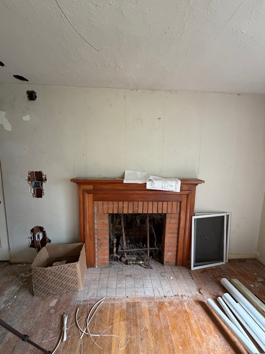 Living room fireplace before demo continues