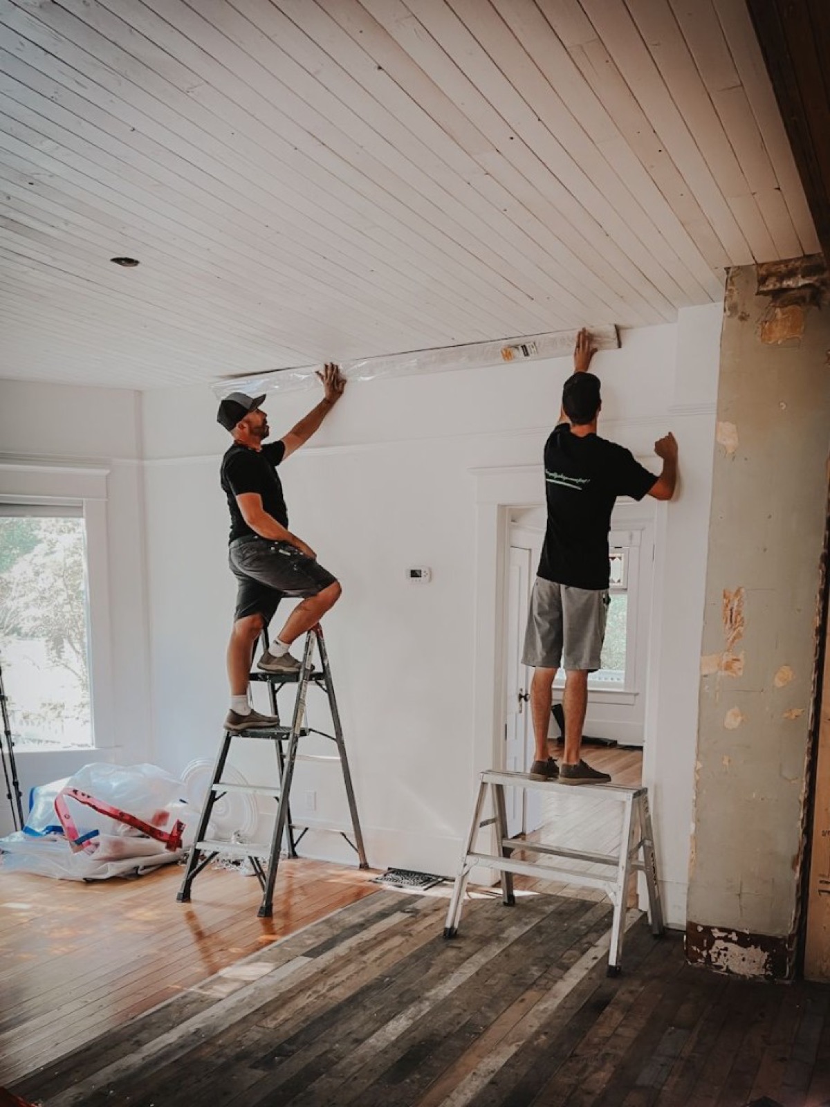 Crew on ladders installing ceiling trim